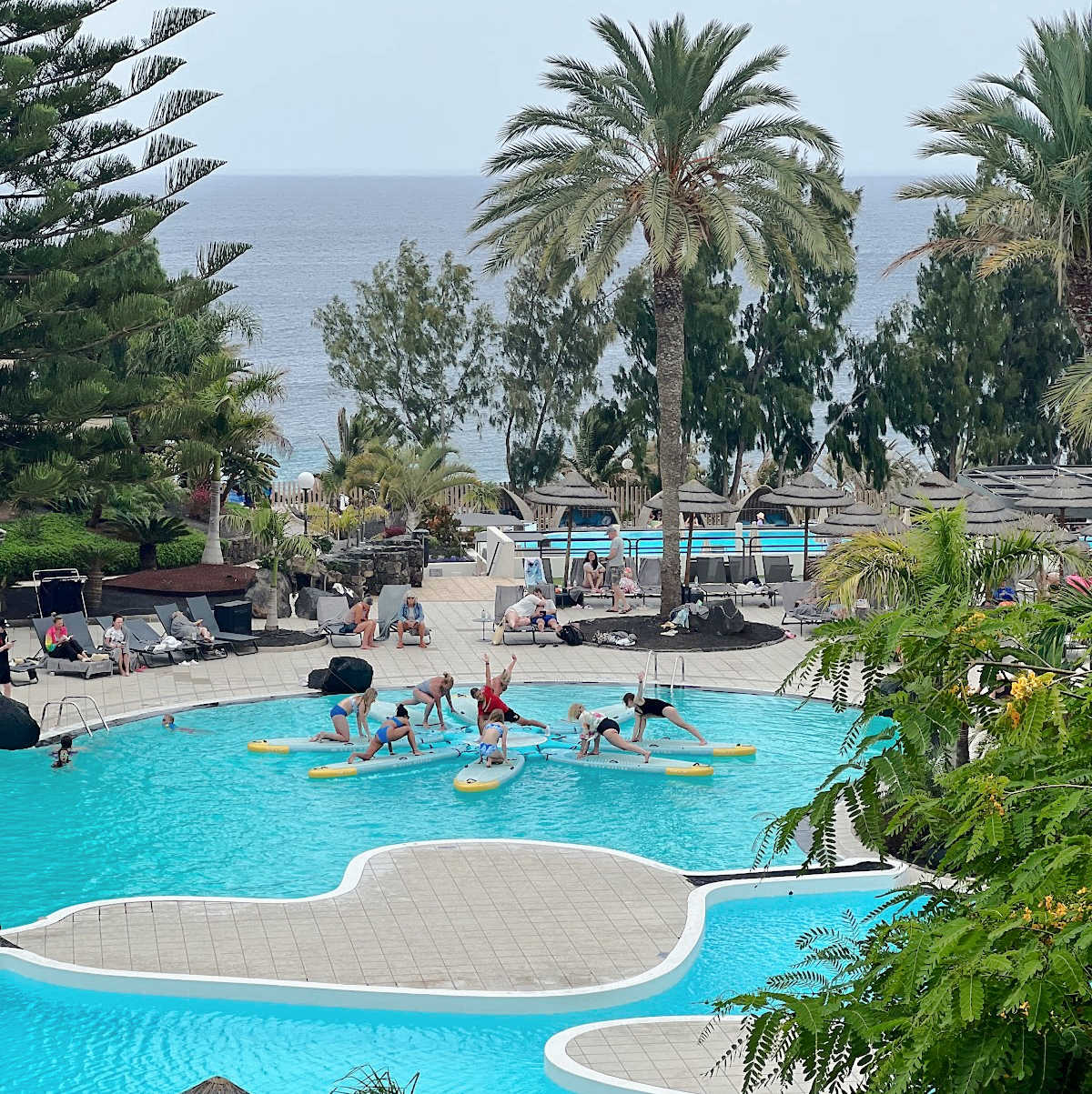 Activity pool at an all inclusive hotel showing paddle board yoga